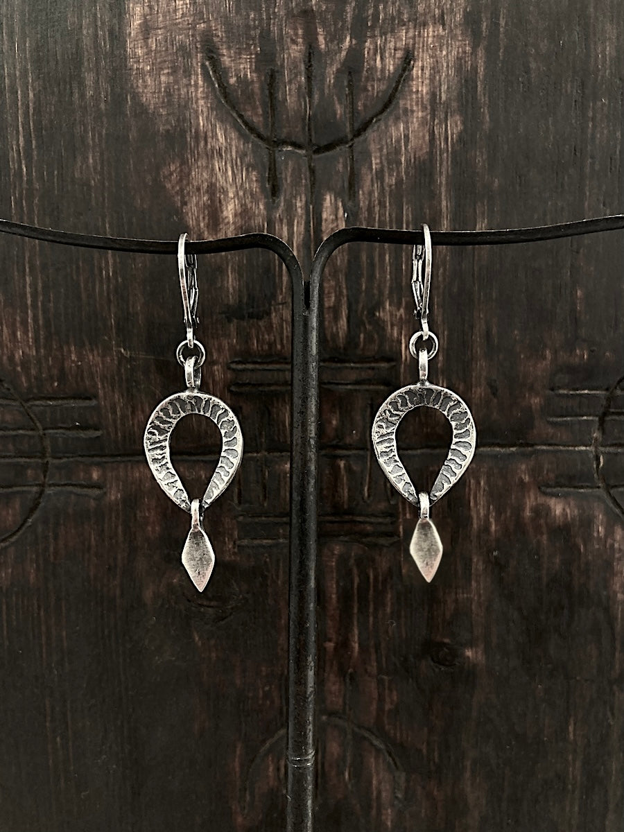 A pair of silver hoop leverback earrings with a striped texture and a drop detail.
