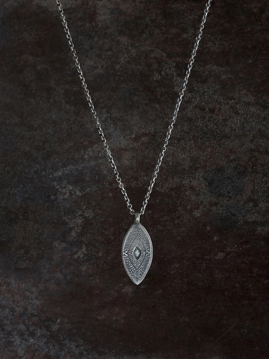 Silver necklace with a and etched leaf pattern centered with a marquise diamond