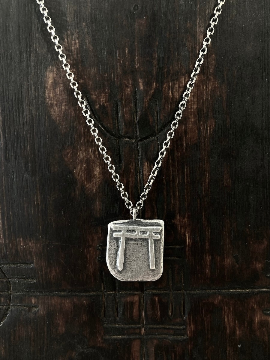 A Torii Gate symbolically marks the transition from the everyday to the sacred.  This mens and womens necklace is hand crafted in sterling silver.