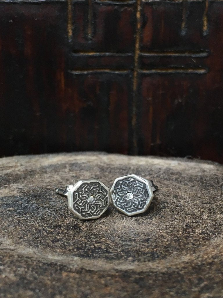 A pair of handmade octagon-shaped silver studs with etched arabesque designs & centered with a diamond