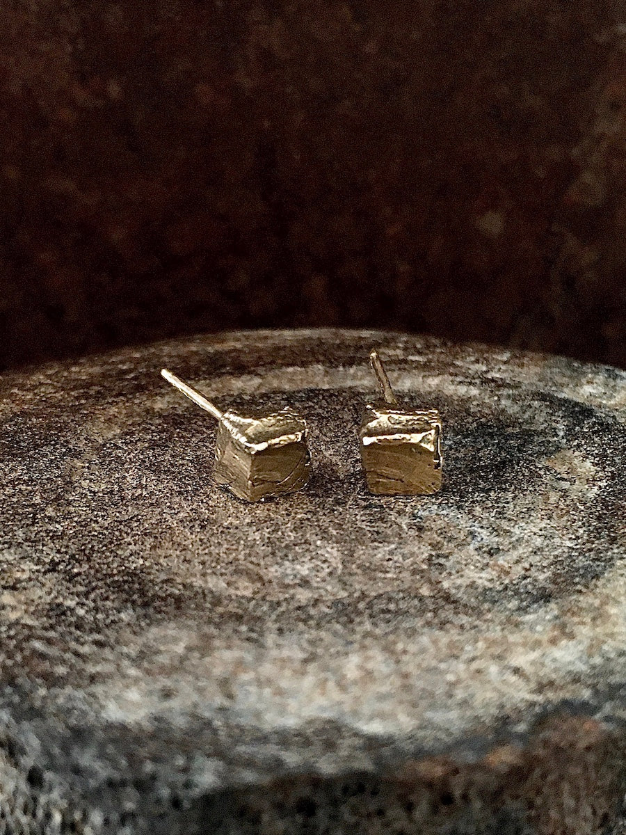 A pair of 14k solid cube-shaped stud earrings with subtle texture