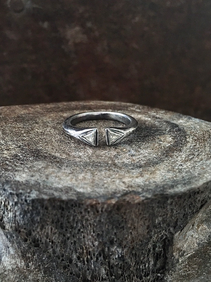 Two rings, one with a gold triangular split front and the other with a silver triangular split front, both set with two trillion diamonds and surrounded by hand beading Mens Jewelry Womens Jewelry
