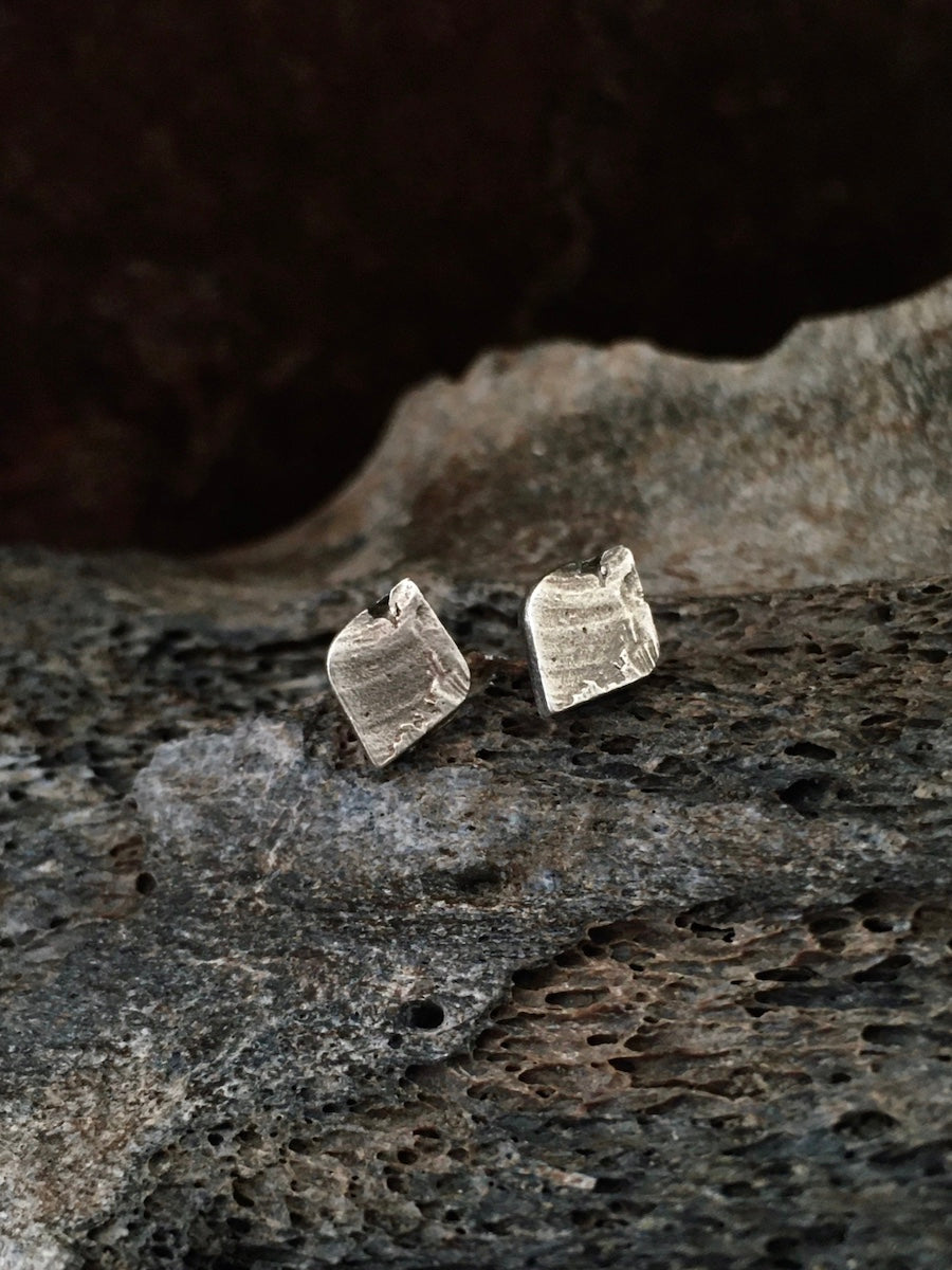 A pair of textured leaf-shaped stud earrings made of aged sterling silver, mens jewelry womens jewelry