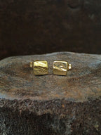 A pair of square stud earrings made with a bark texture in 14k gold Mens Jewelry Womens Jewelry