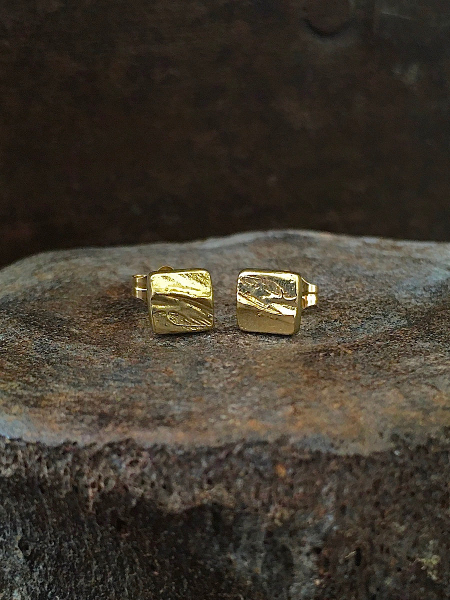 A pair of square stud earrings made with a bark texture in 14k gold Mens Jewelry Womens Jewelry