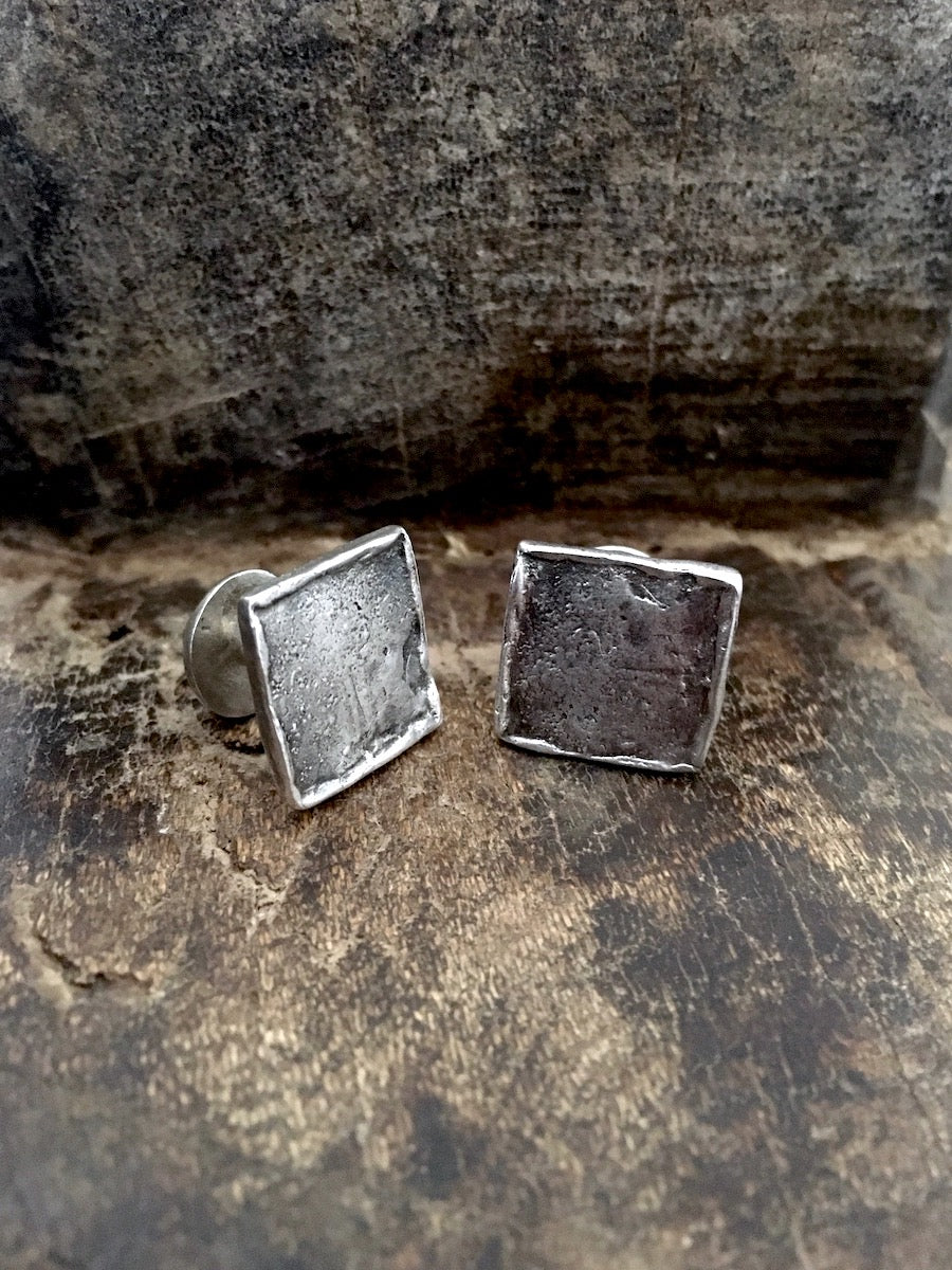A pair of handmade 925 sterling silver cufflinks with a stone texture.