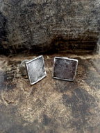A pair of handmade 925 sterling silver cufflinks with a stone texture.